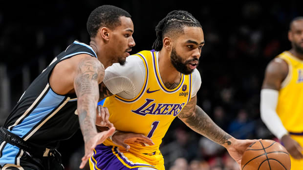 Los Angeles Lakers guard D’Angelo Russell dribbles against Atlanta Hawks guard Dejounte Murray